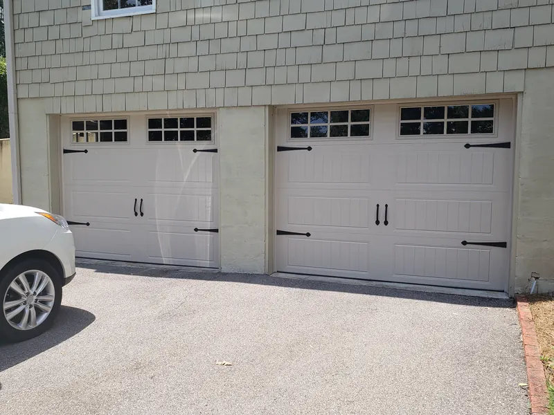 The same openings with new tan carriage-style doors with black hardware